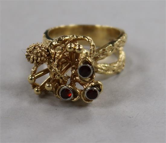 A 1970s? 14ct gold and garnet set rustic cocktail ring, size M.